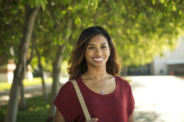 a woman wearing red smiles towards the camera