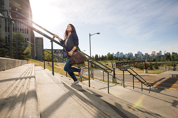 Women walks up the steps at Heritage Hall 