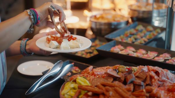 A close-up a buffet table with assortment of meats and cheese