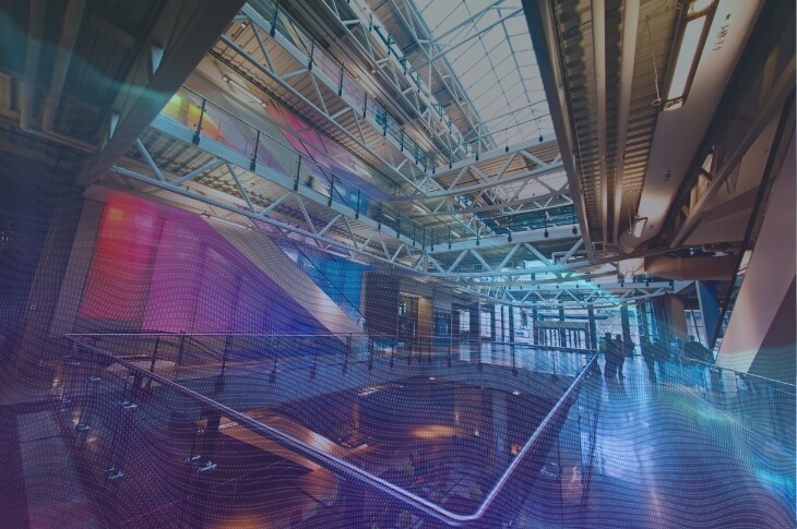 An upward view of Aldred Centre's interior, featuring a blue overlay.