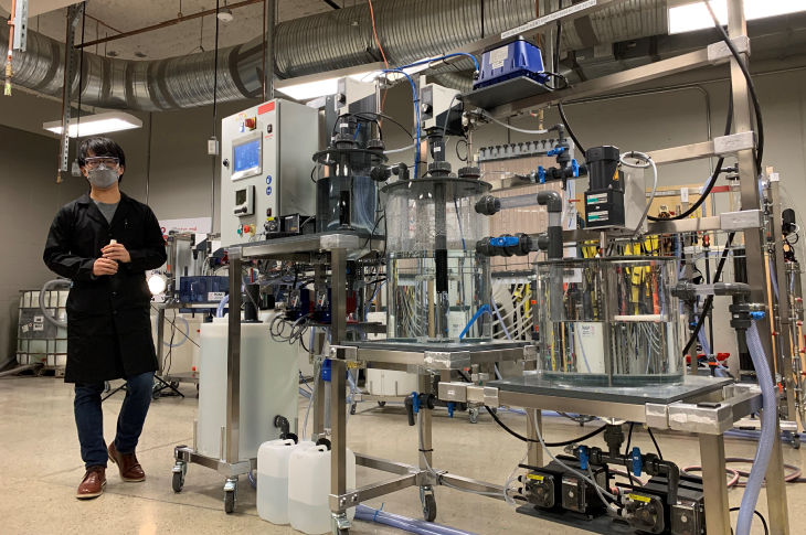 An instructor speaks to students in a water treatment lab on campus.